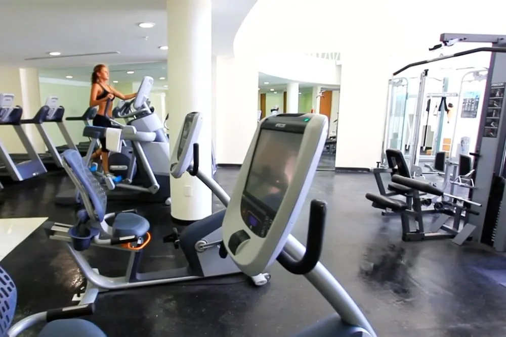Fitness center with cardio and weight machines at The Hacienda at Krystal Grand Puerto Vallarta.