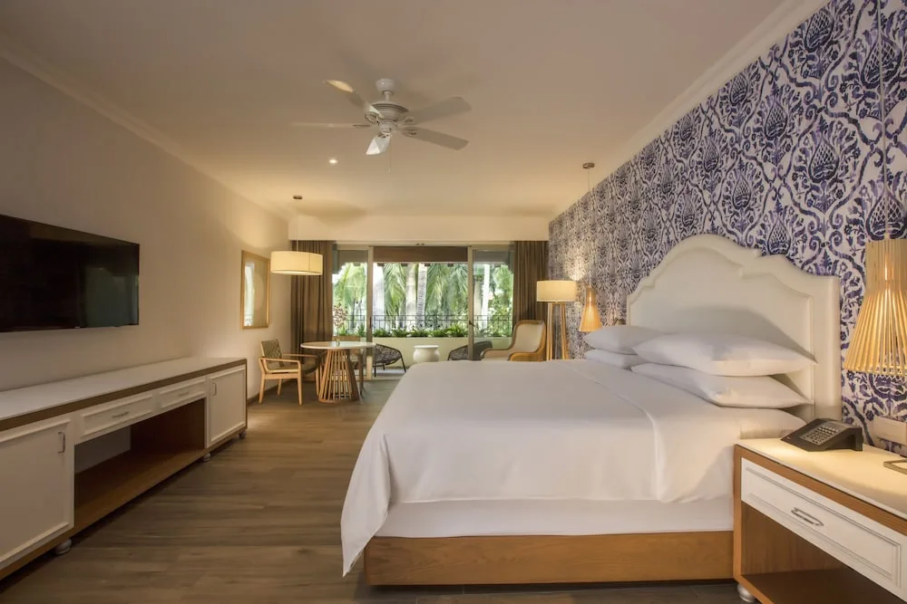 King guest room with balcony seating at The Hacienda at Krystal Grand Puerto Vallarta.