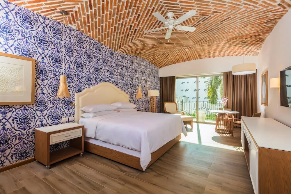 King guest room with brick ceiling at The Hacienda at Krystal Grand Puerto Vallarta.