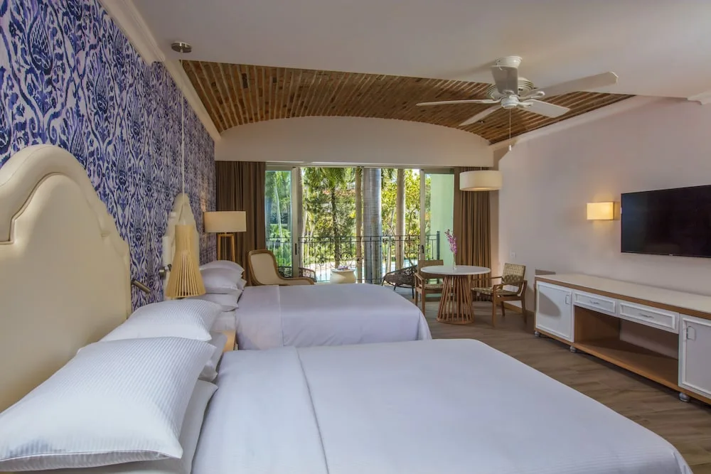 Two-bed guest room with balcony at The Hacienda at Krystal Grand Puerto Vallarta.