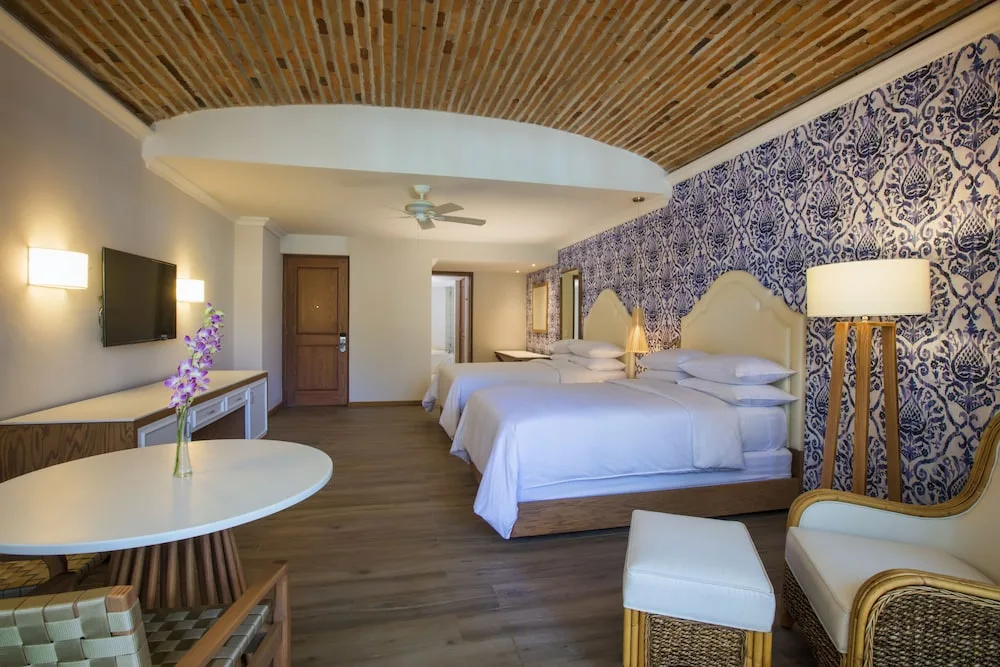 Two-bed guest room with brick ceiling at The Hacienda at Krystal Grand Puerto Vallarta.
