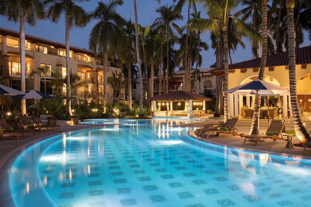 Illuminated pool courtyard at The Hacienda at Krystal Grand Puerto Vallarta.