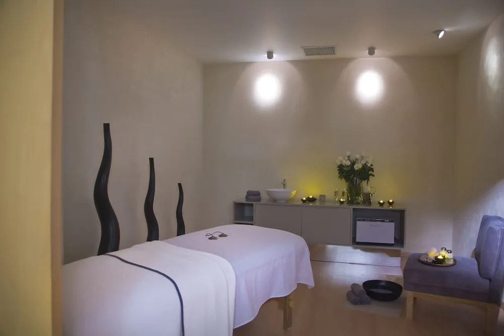 Spa treatment room with massage table at The Hacienda at Krystal Grand Puerto Vallarta.