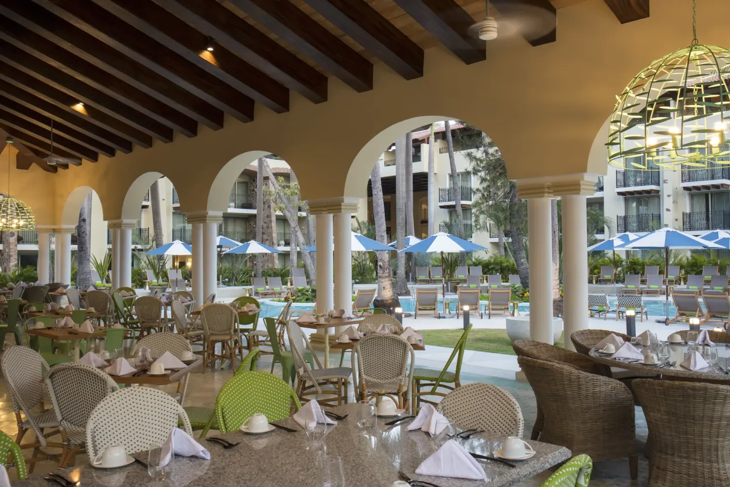 Covered poolside dining terrace at The Hacienda at Krystal Grand Puerto Vallarta.