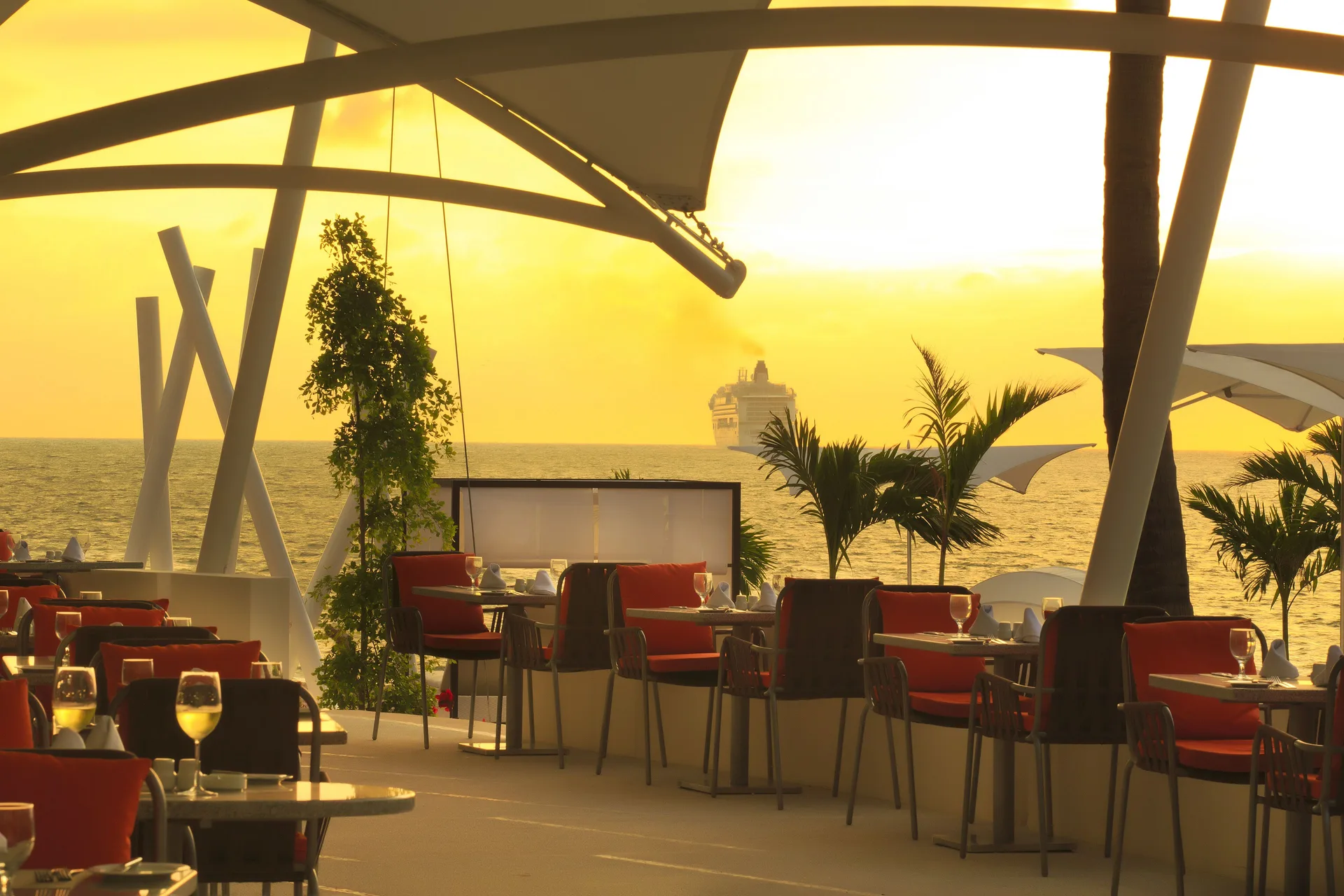 Oceanfront dining terrace at sunset at The Hacienda at Krystal Grand Puerto Vallarta.