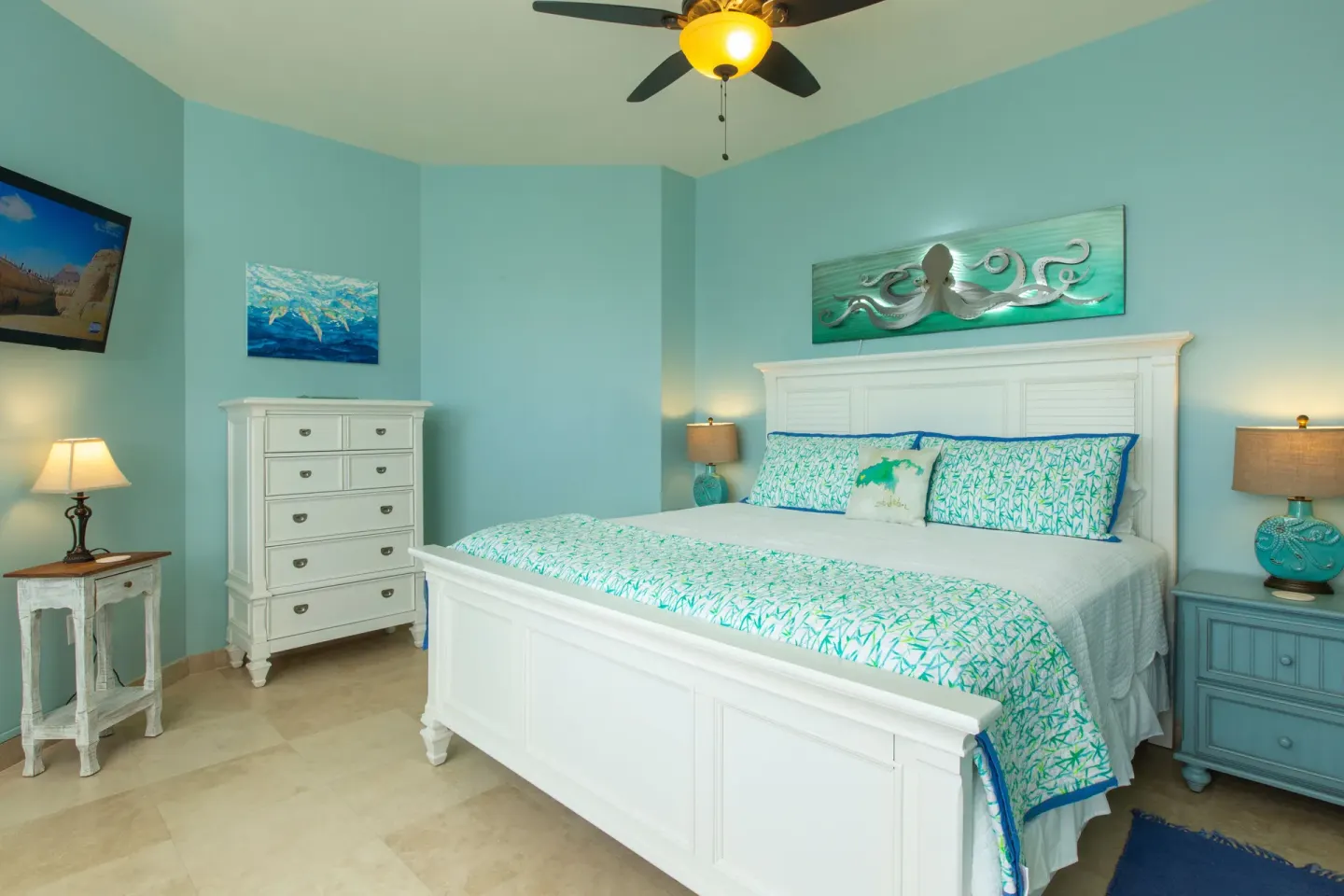 Aqua guest room with white bed and coastal decor at The Hills, St John.