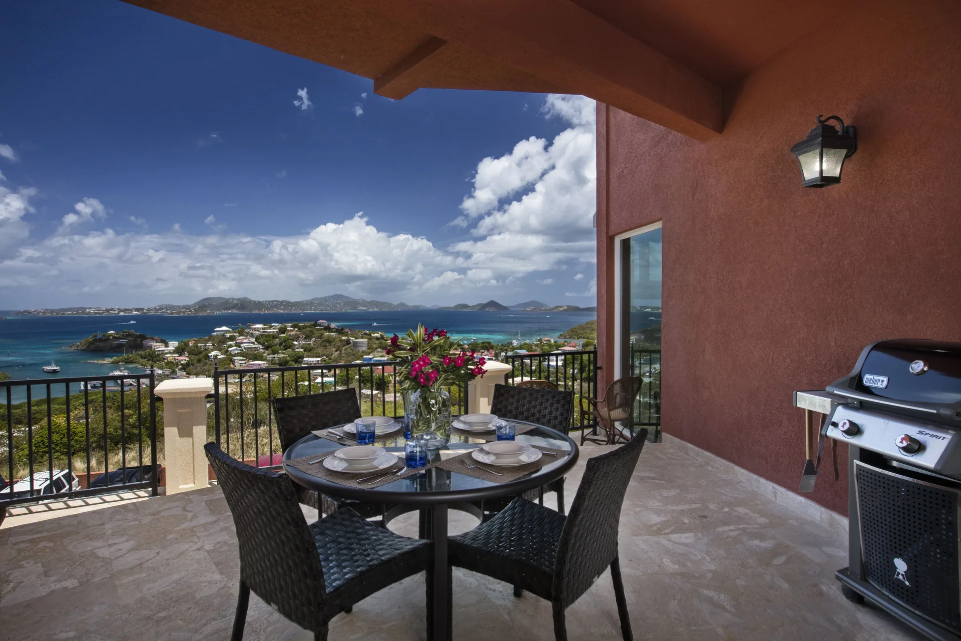 Balcony dining table with grill and island water views at The Hills, St John.