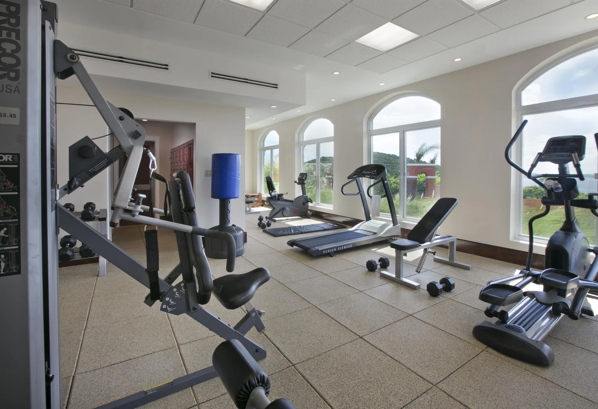 Fitness room with cardio machines and arched windows at The Hills, St John.