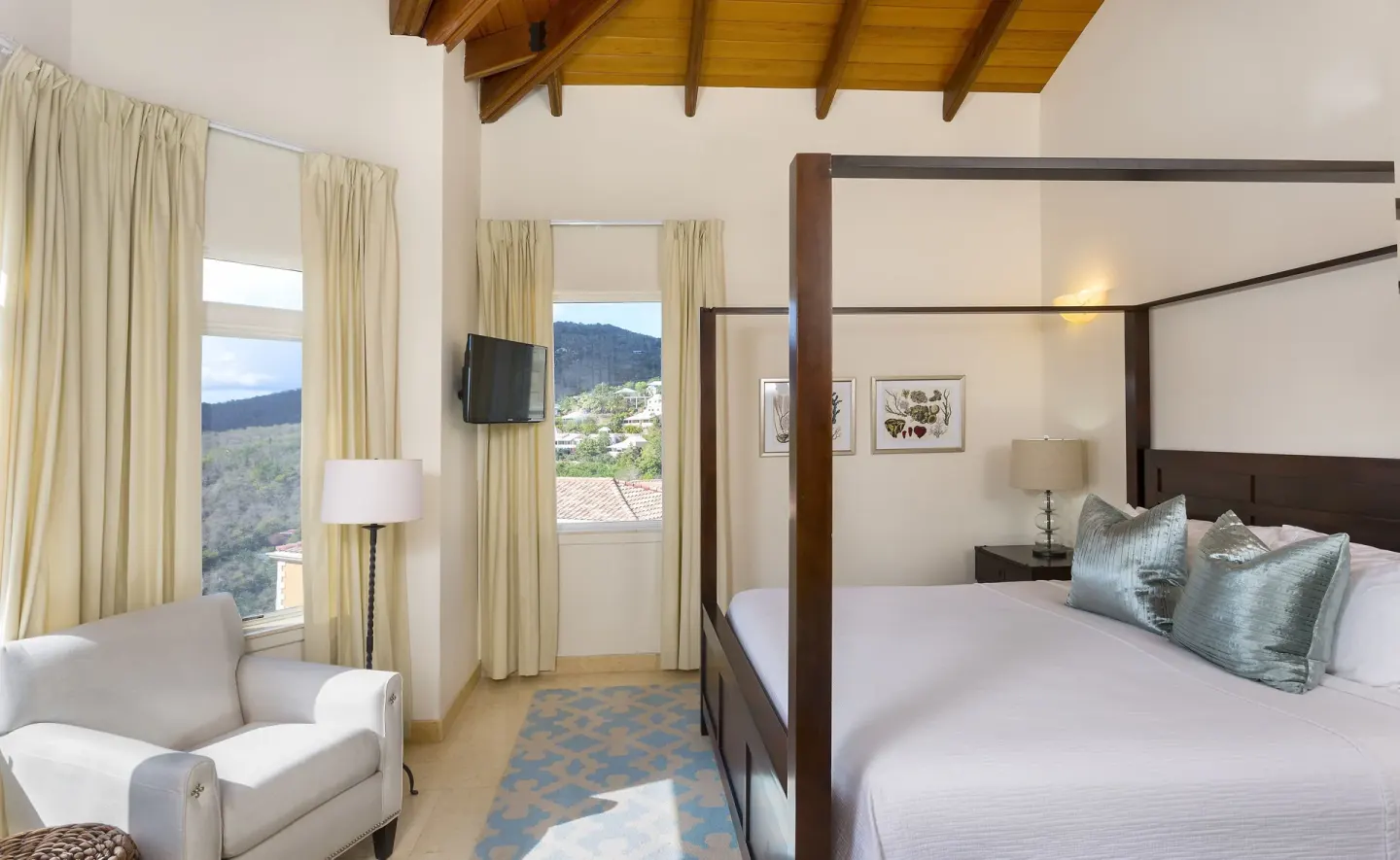 Four-poster guest room with mountain views at The Hills, St John.