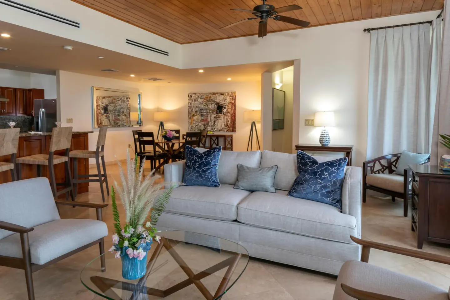 Living area with sofa, glass table, dining space, and kitchen at The Hills, St John.