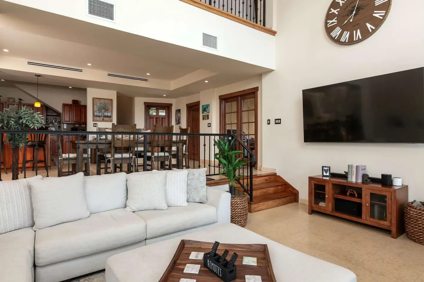 Living room with sofa, wall-mounted TV, and raised dining area at The Hills, St John.