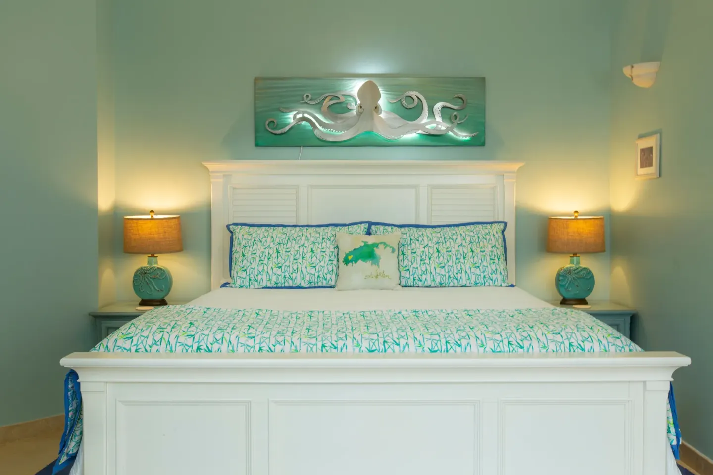 White king bed with turquoise linens and octopus art at The Hills, St John.