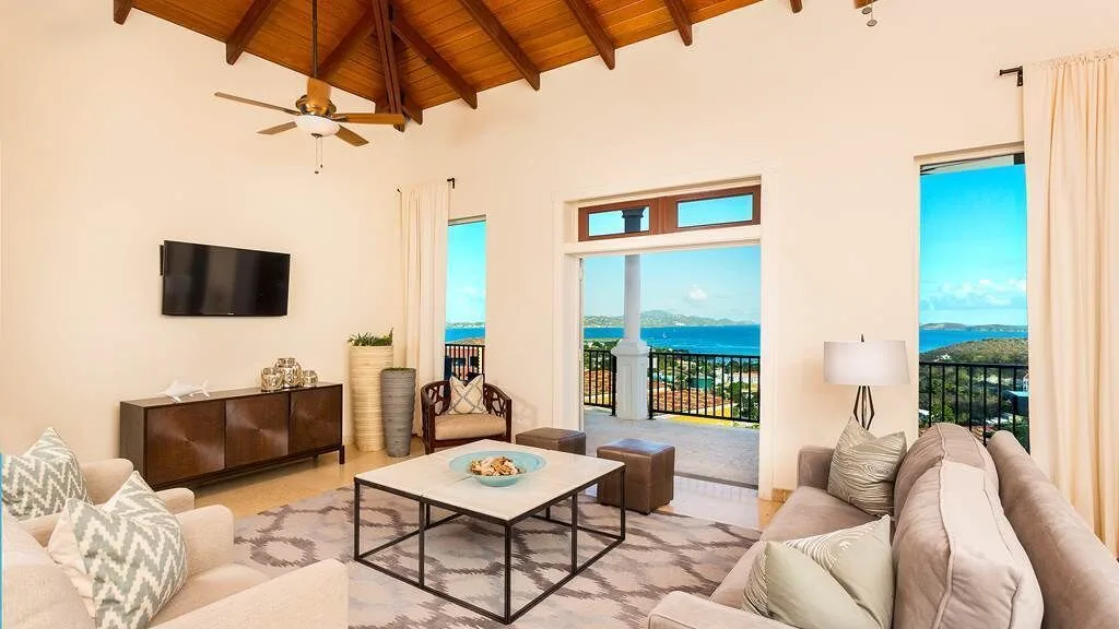 Vaulted living room opening to a balcony and ocean view at The Hills, St John.