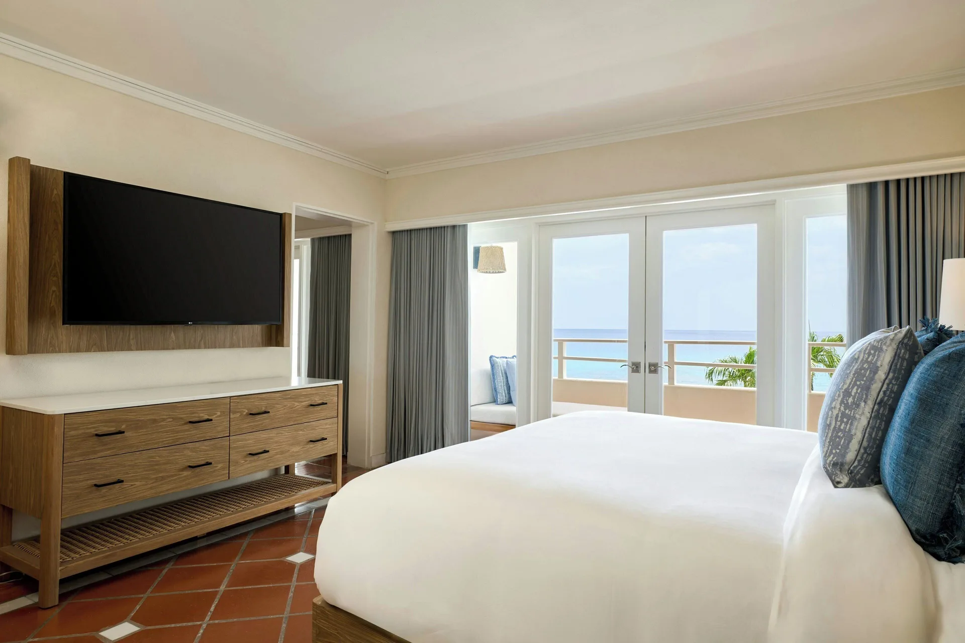 Ocean View 1 Bedroom Suite bedroom with king bed, TV and balcony view at The House.