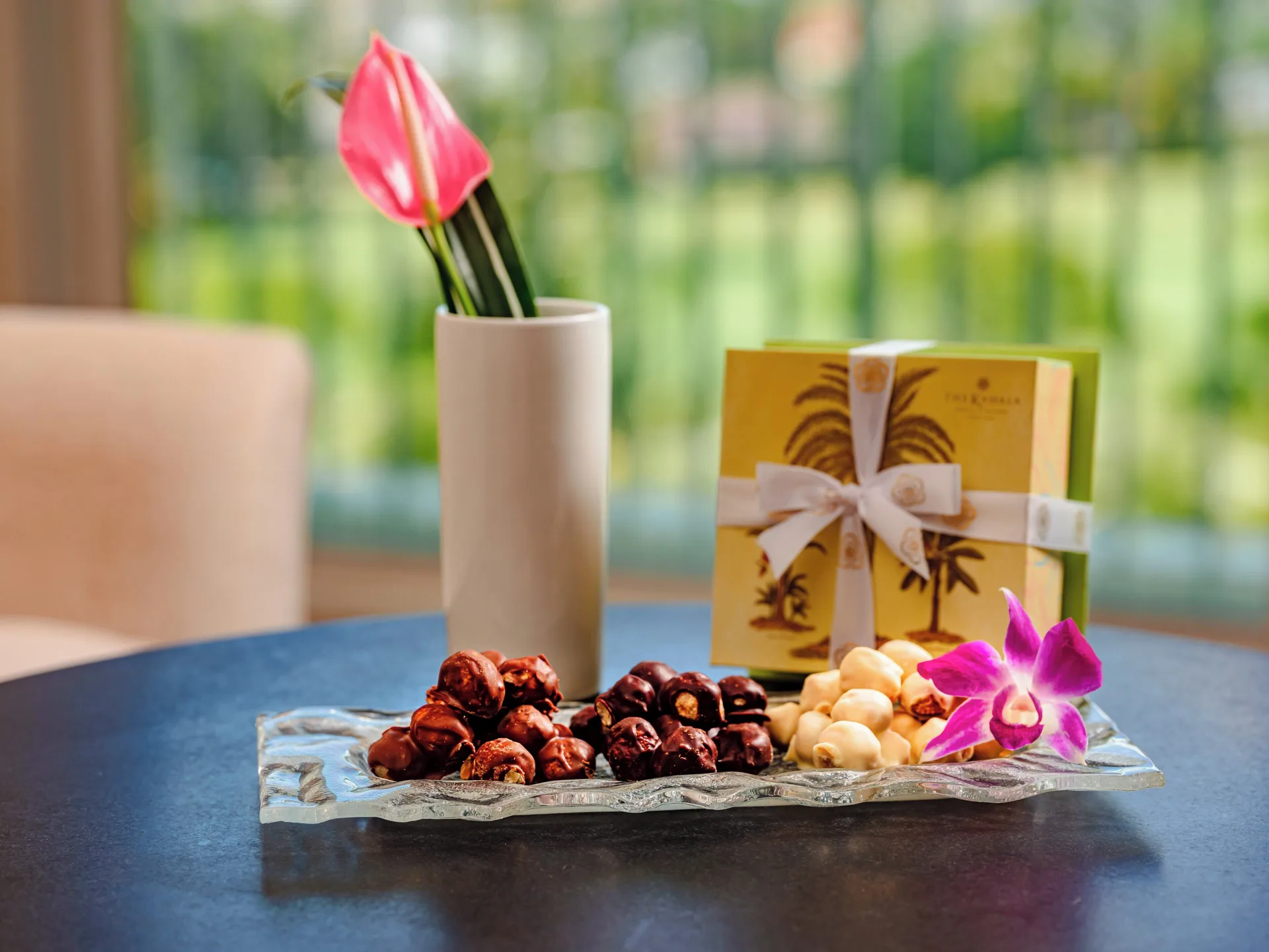 Chocolate-covered nuts, orchid and a flower arrangement at The Kahala Hotel & Resort.