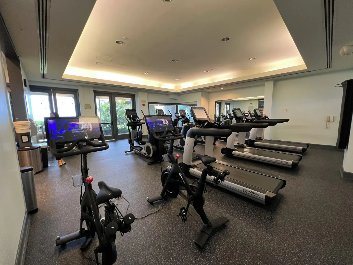 Fitness room with treadmills, bikes, and cardio screens at The Kahala Hotel & Resort.