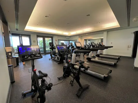 Fitness room with treadmills, bikes, and cardio screens at The Kahala Hotel & Resort.