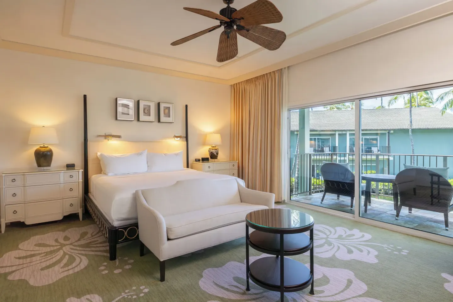 King bed guest room with sofa and furnished balcony at The Kahala Hotel & Resort.