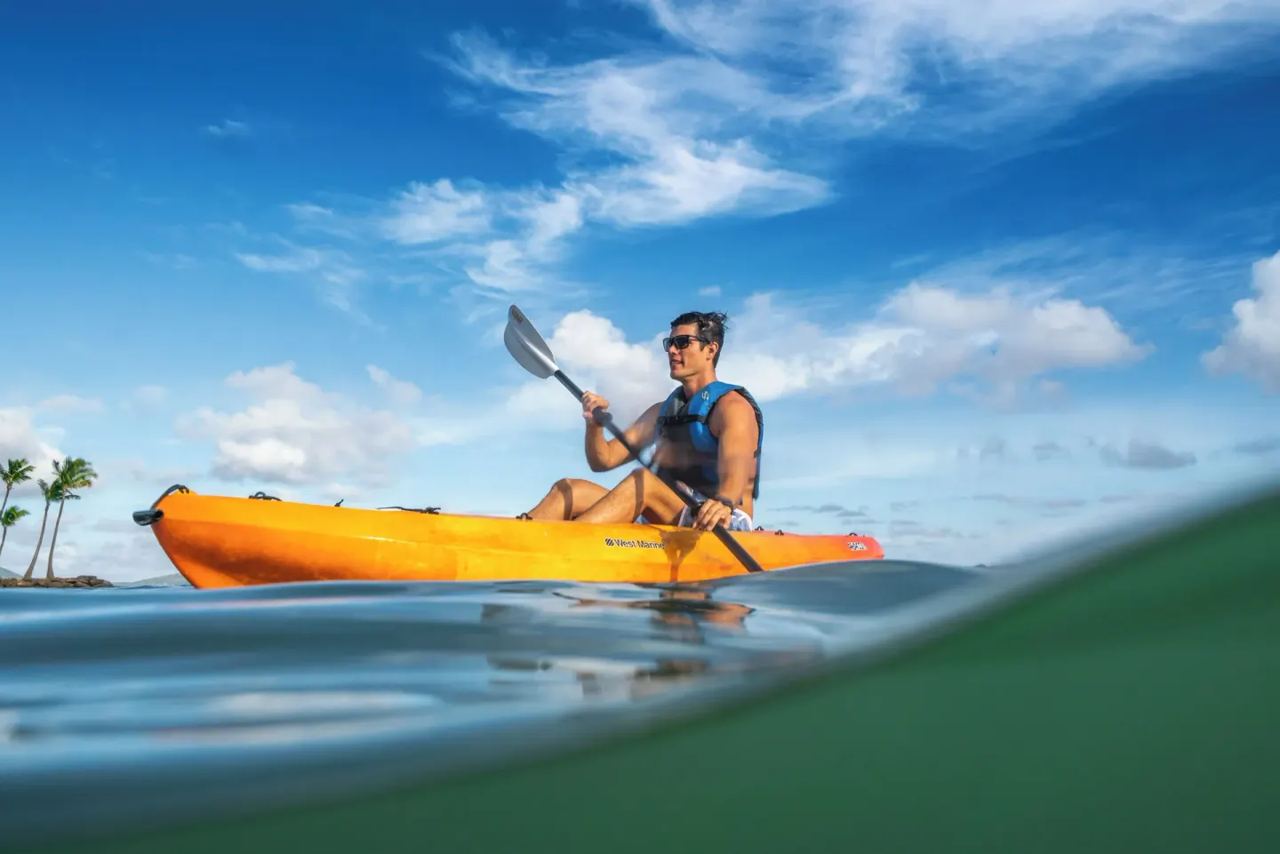 Guest kayaking offshore at The Kahala Hotel & Resort.