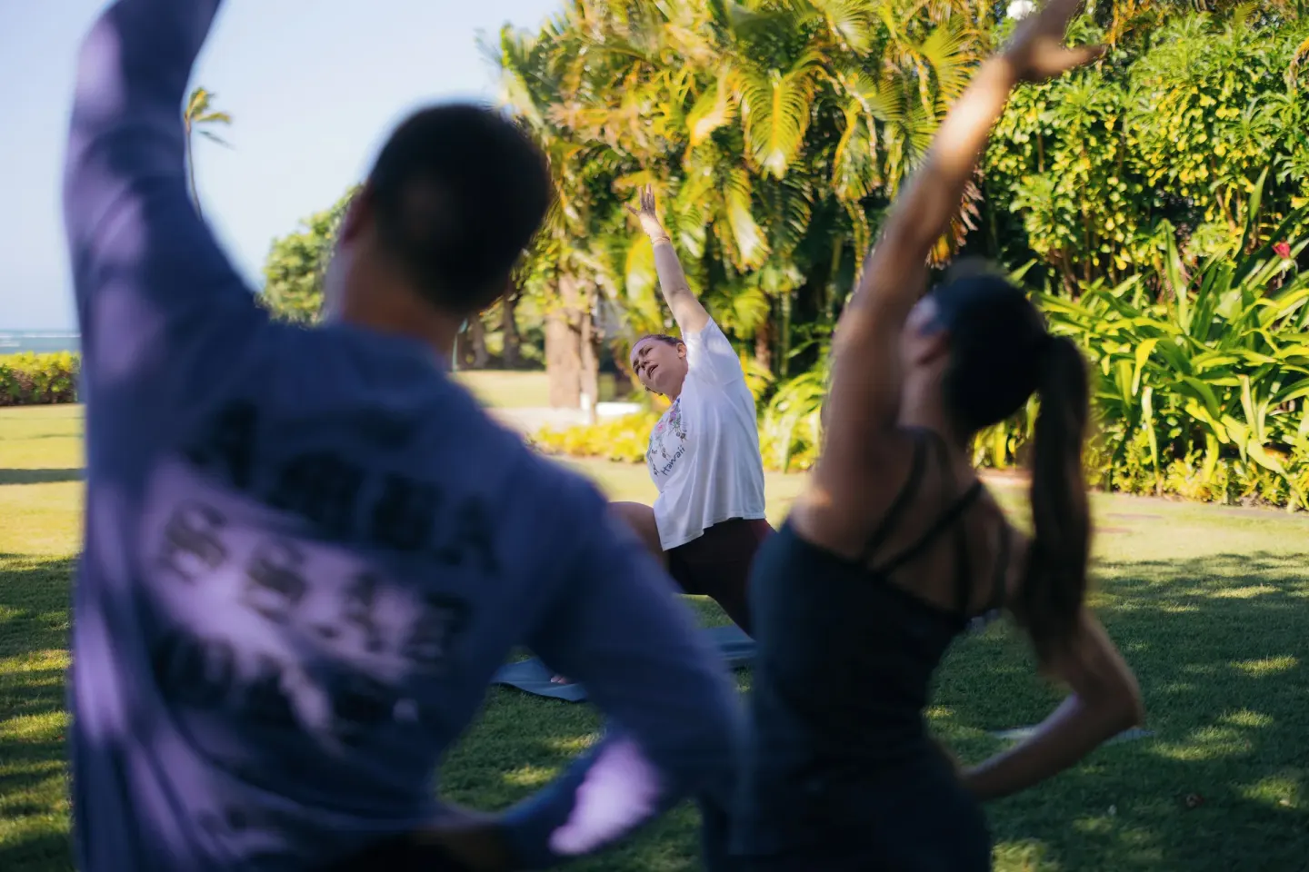 Outdoor yoga class on the lawn at The Kahala Hotel & Resort.