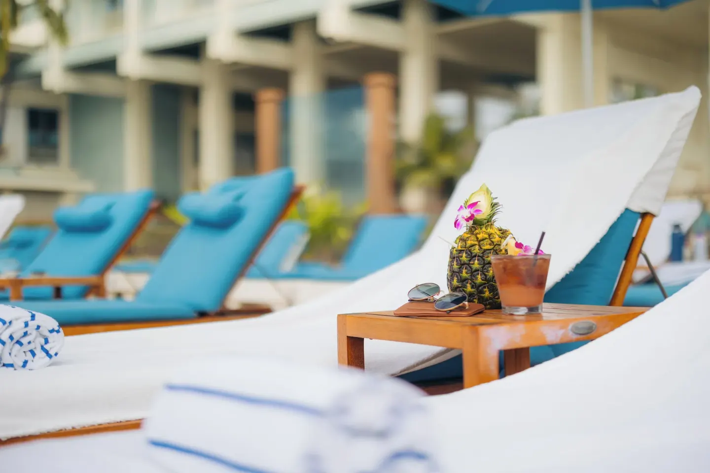 Lounge chairs with poolside drinks at The Kahala Hotel & Resort.