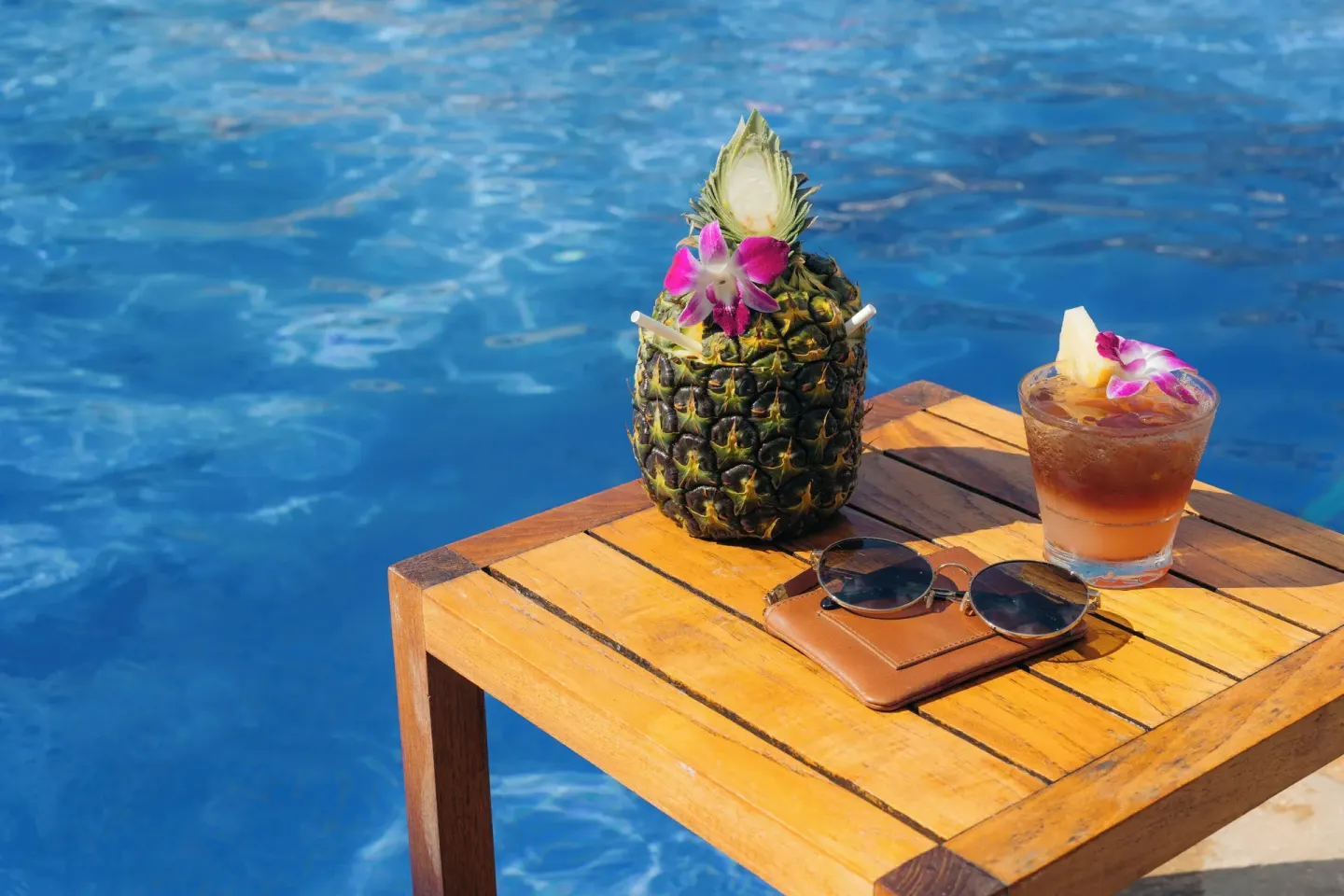 Poolside tropical drinks and sunglasses at The Kahala Hotel & Resort.