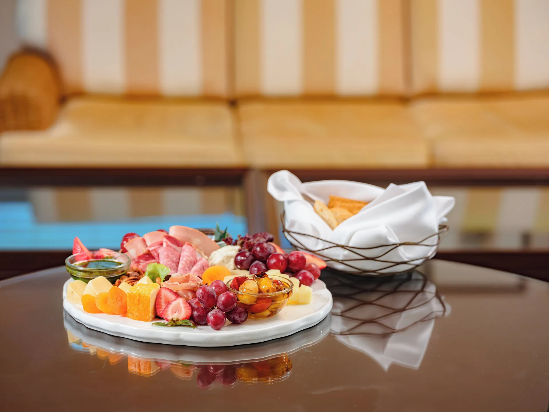Charcuterie, fruit, and cheese platter on a table at The Kahala Hotel & Resort.