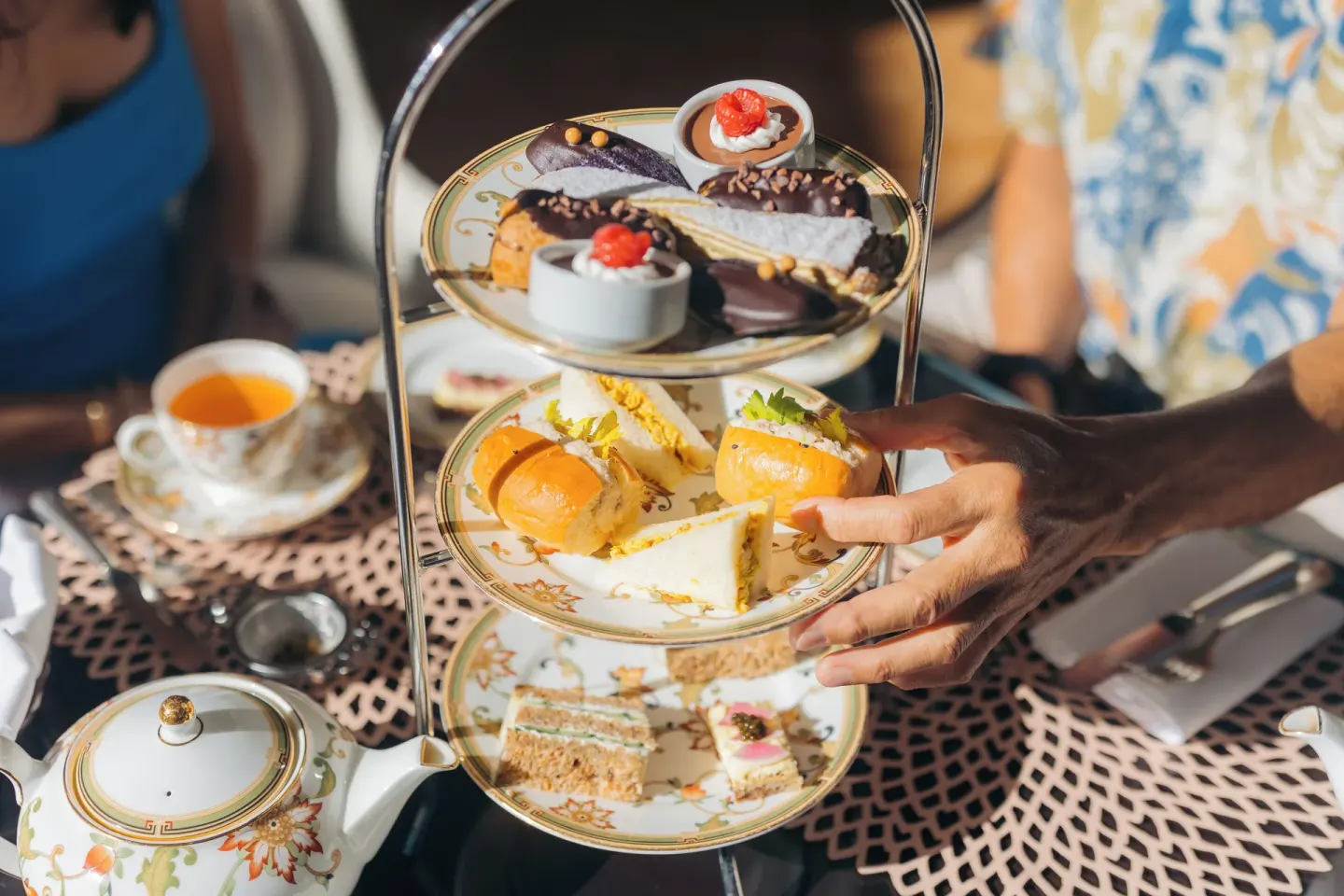 Afternoon tea tray with pastries, sandwiches, and tea at The Kahala Hotel & Resort.