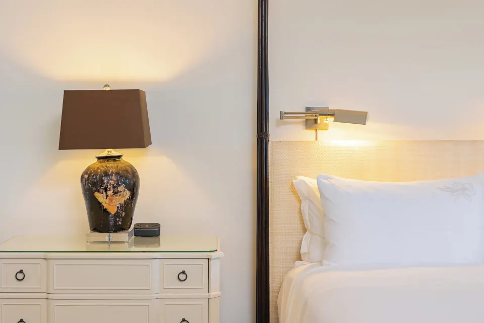 Bedside lamp and pillows in a Dolphin Lanai room at The Kahala Hotel & Resort.
