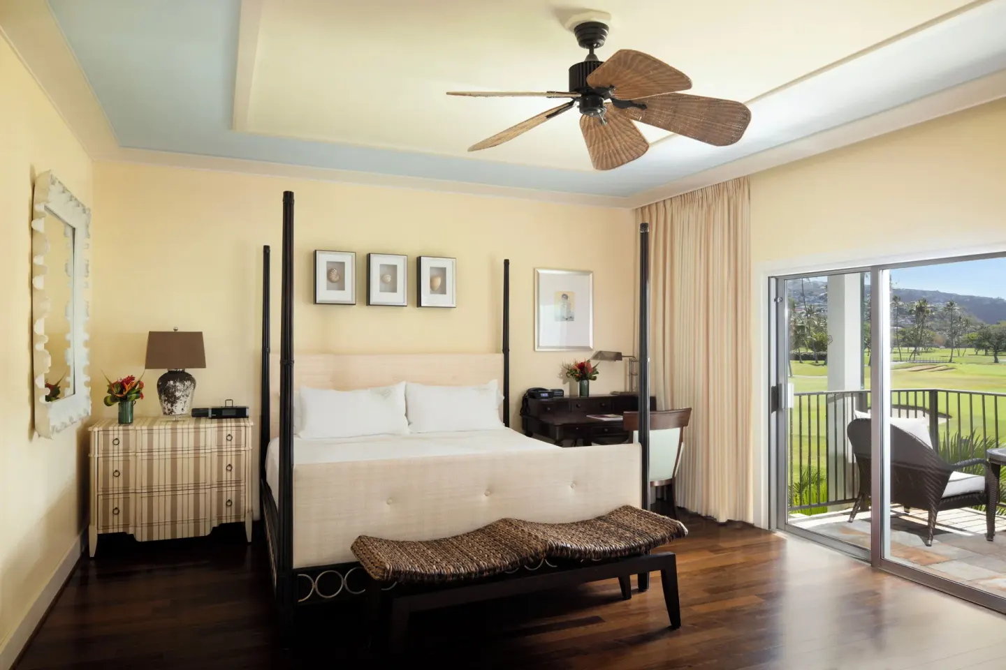The Kahala Hotel & Resort bedroom with four-poster bed and balcony at The Kahala Hotel & Resort.