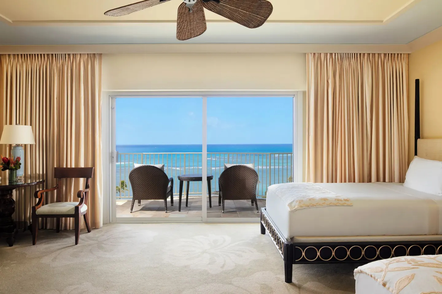 Ocean Front Lanai room with bed, desk area, and ocean balcony at The Kahala Hotel & Resort.