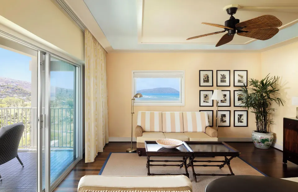 Partial Ocean View Suite living room with sofa and balcony at The Kahala Hotel & Resort.