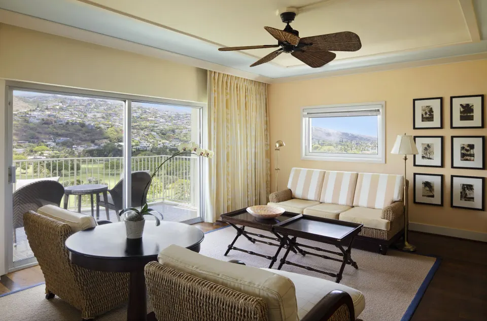 Partial Ocean View Suite sitting area with balcony and hillside view at The Kahala Hotel & Resort.