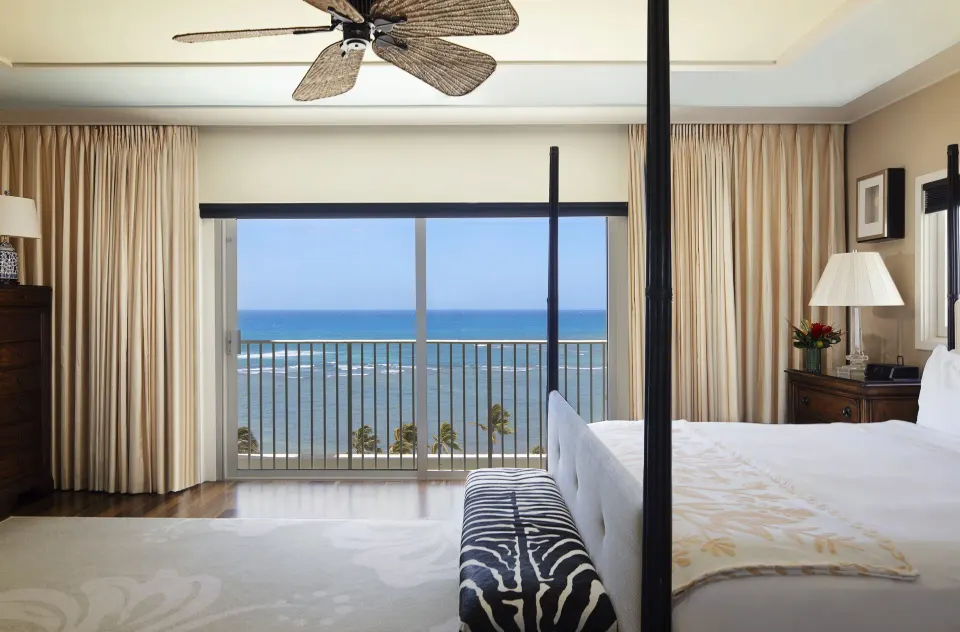 Tower Suite I bedroom with four-poster bed facing an ocean balcony at The Kahala Hotel & Resort.