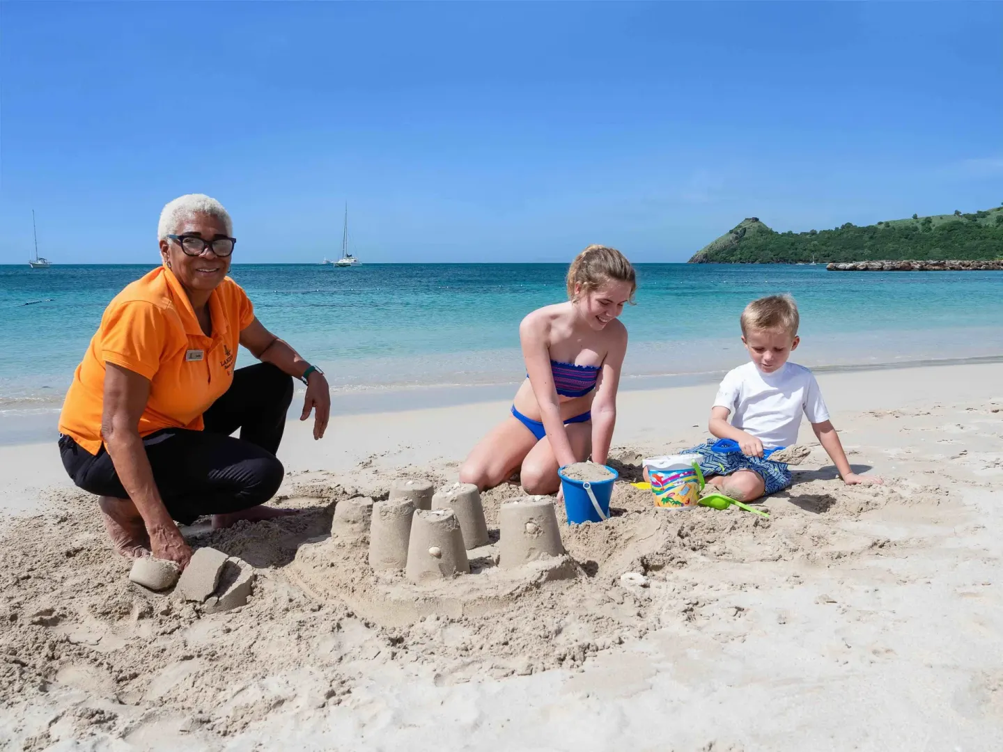 Children building sandcastles on the beach at The Landings Resort & Spa.