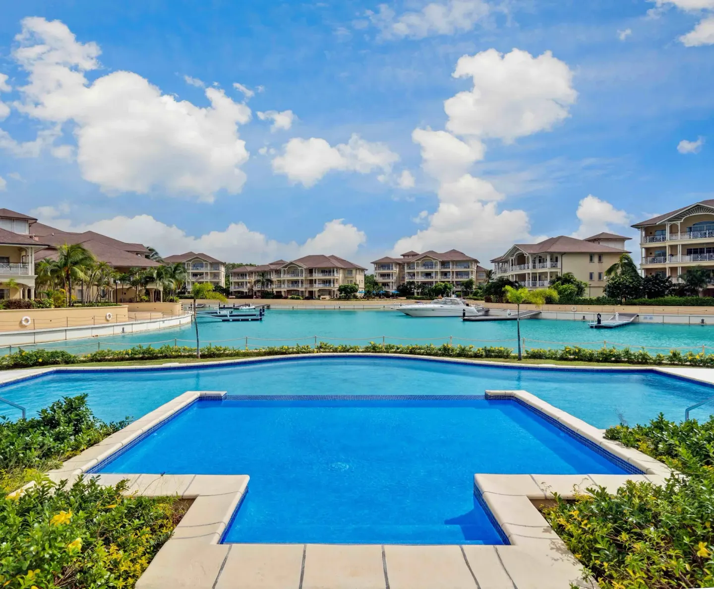 Infinity-style pool facing the marina and resort buildings at The Landings Resort & Spa.