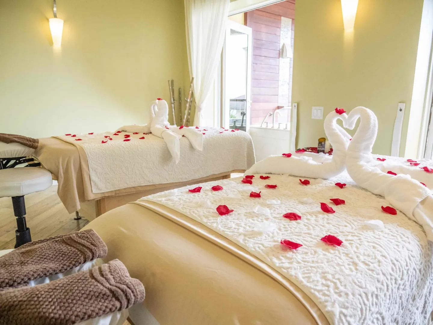 Spa treatment beds with towel swans and rose petals at The Landings Resort & Spa.