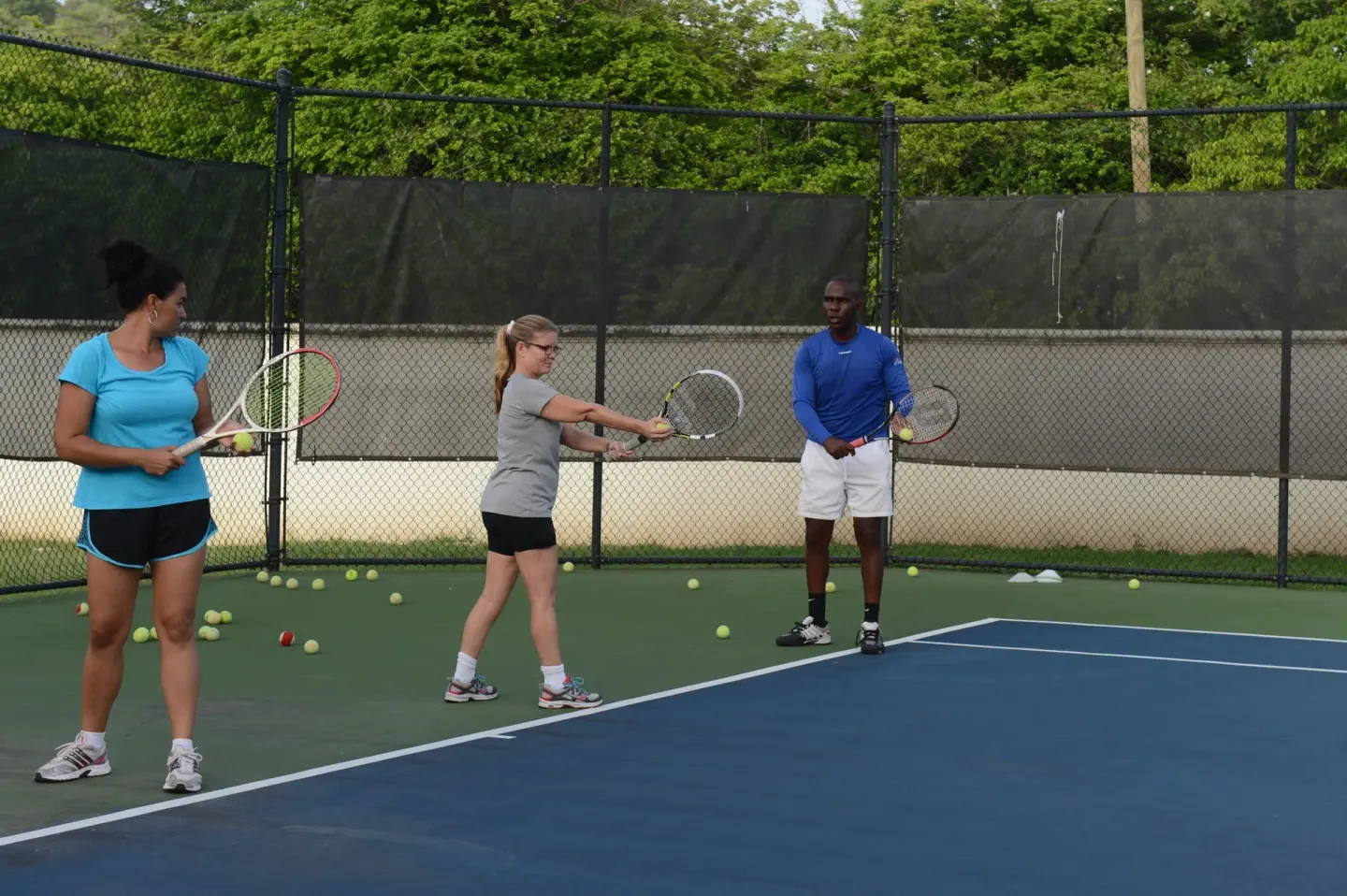 Tennis lesson on an outdoor court at The Landings Resort & Spa.