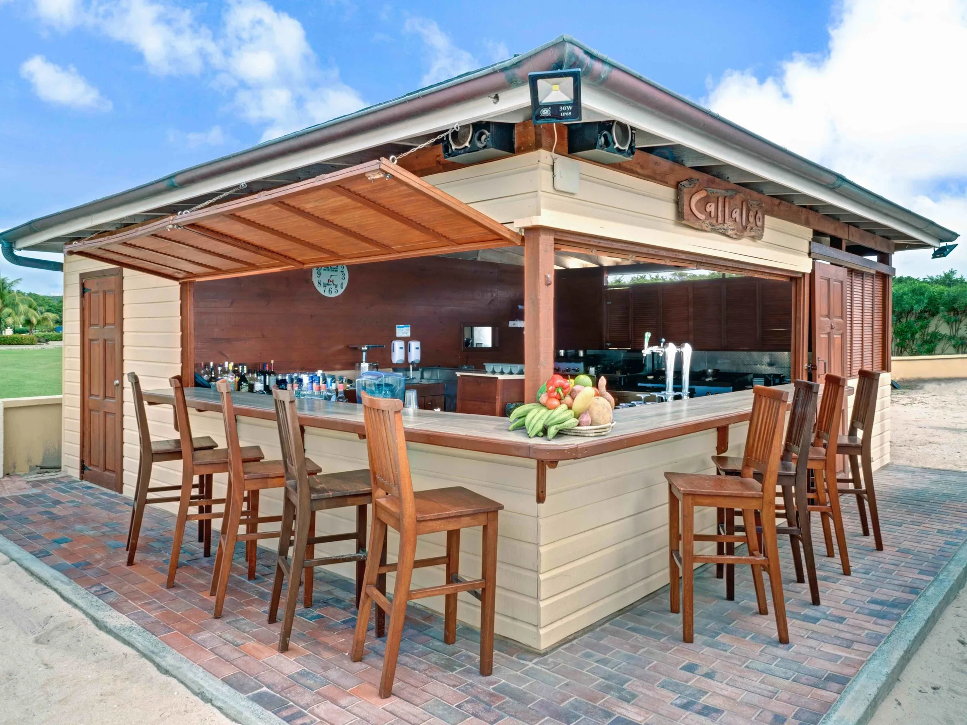 Callaloo beach bar with stools and open service windows at The Landings Resort & Spa.