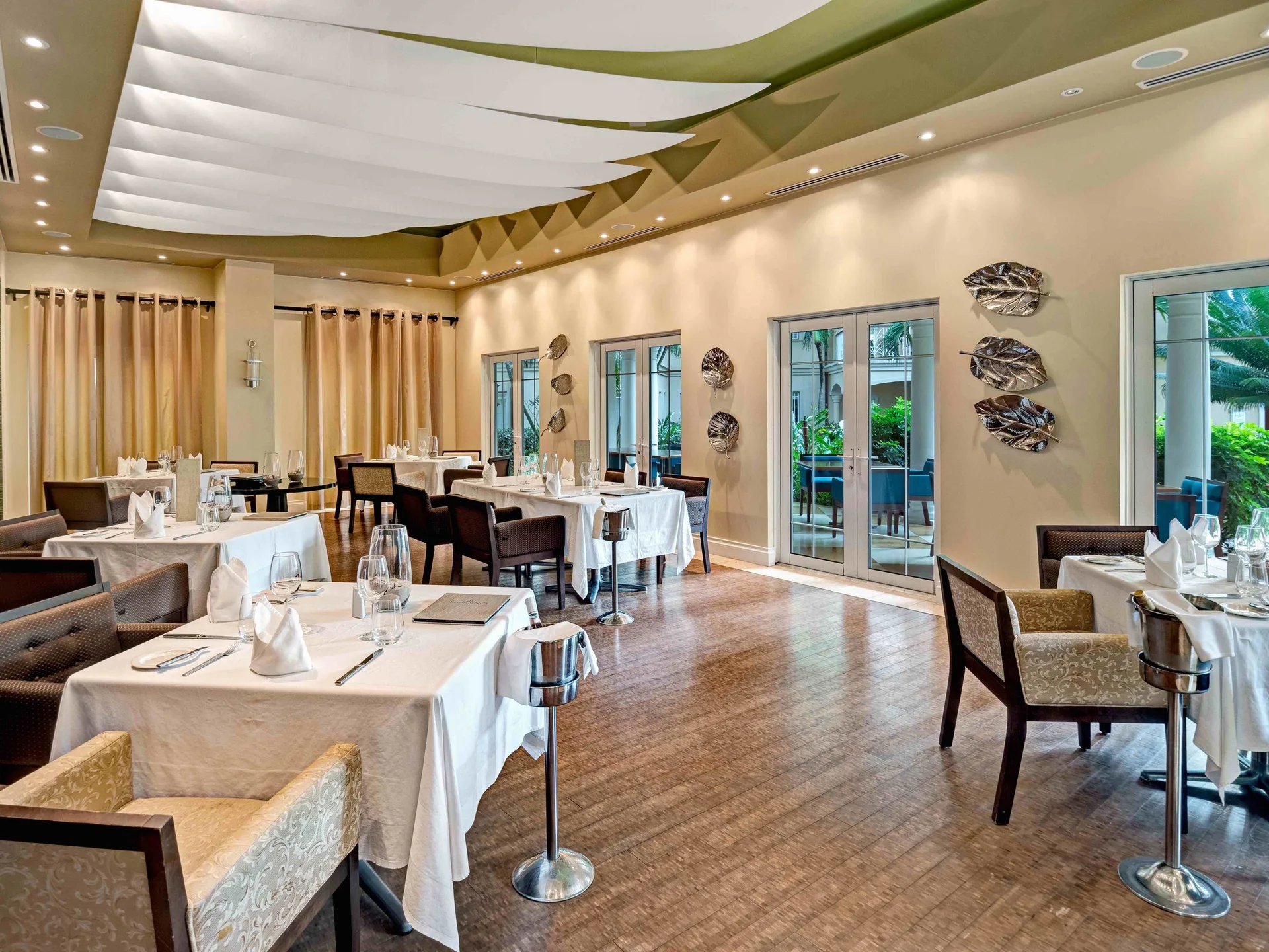 Elegant dining room with white tablecloths at The Landings Resort & Spa.