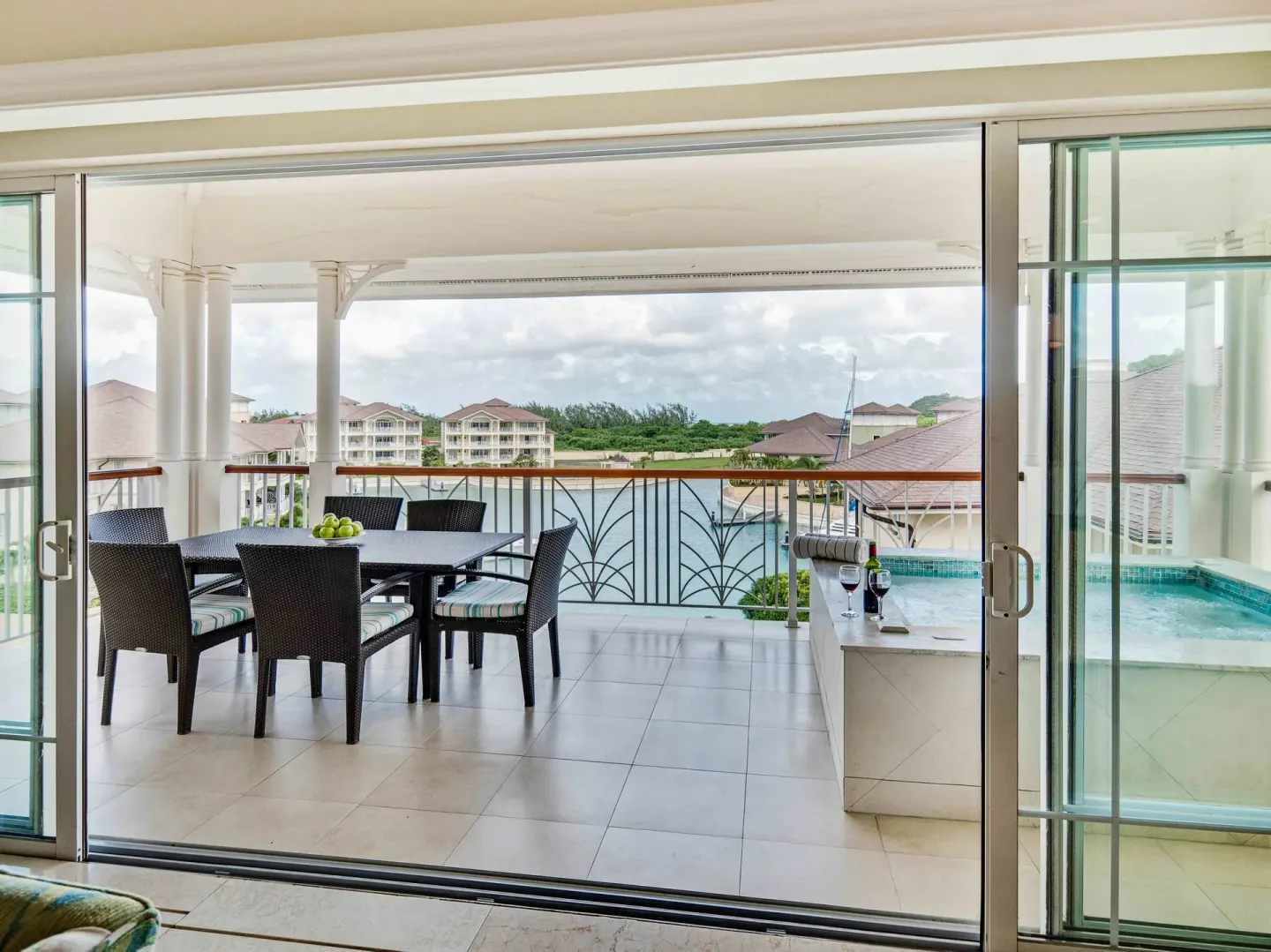 Marina-view balcony with dining table and plunge pool at The Landings Resort & Spa.