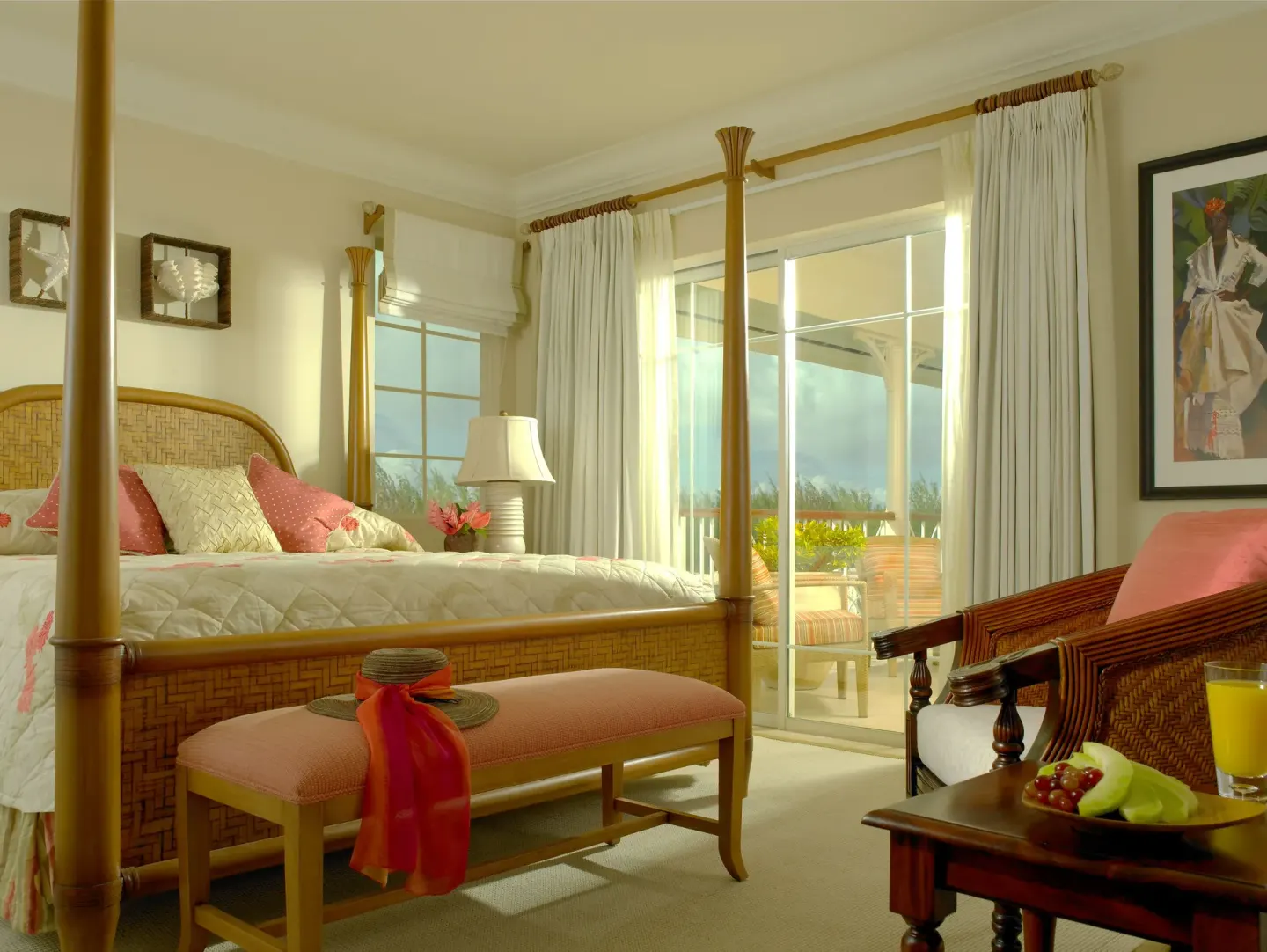 Four-poster bed and balcony seating in a villa suite at The Landings Resort & Spa.