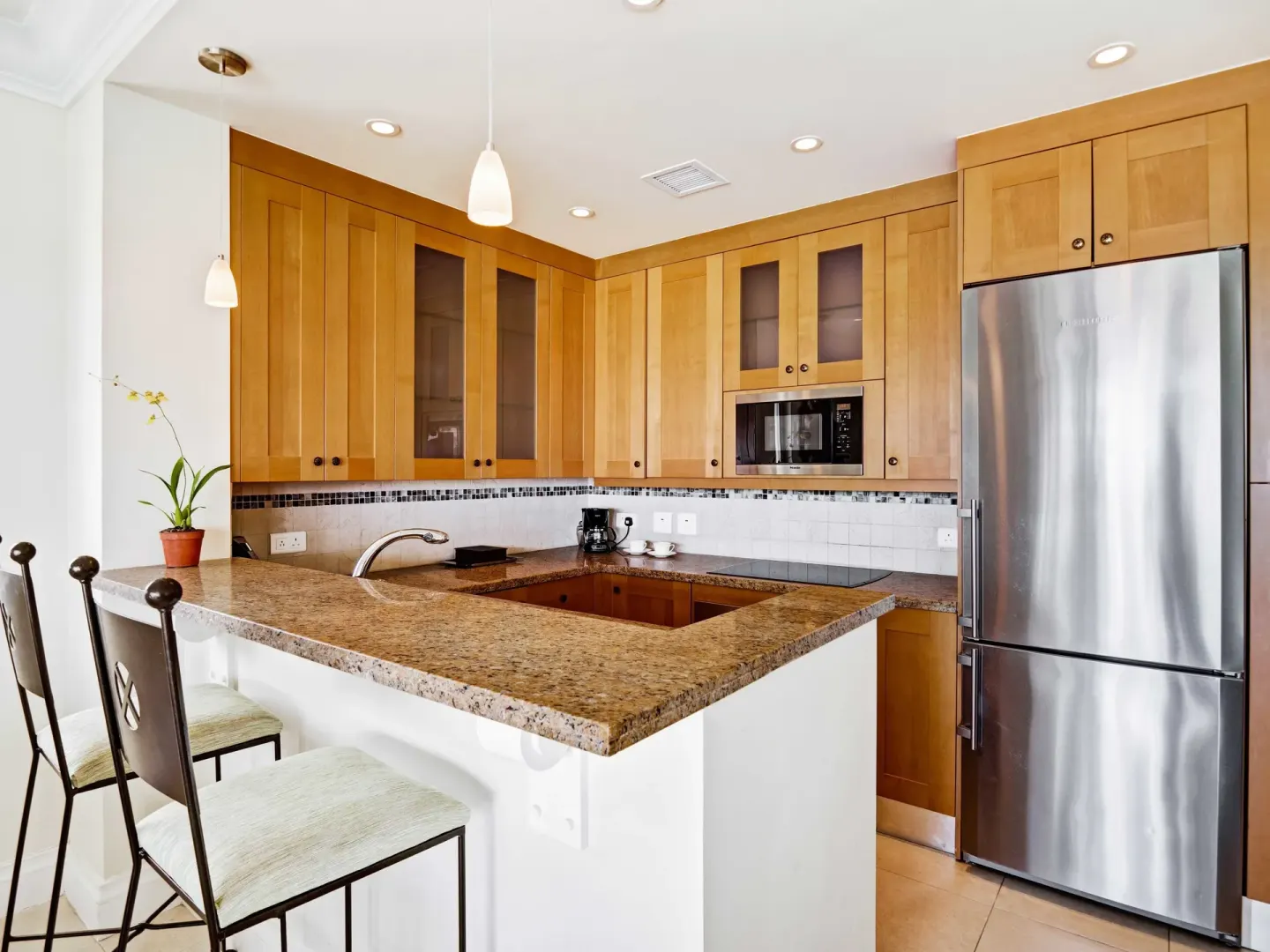 Villa suite kitchen with granite counter and stainless refrigerator at The Landings Resort & Spa.