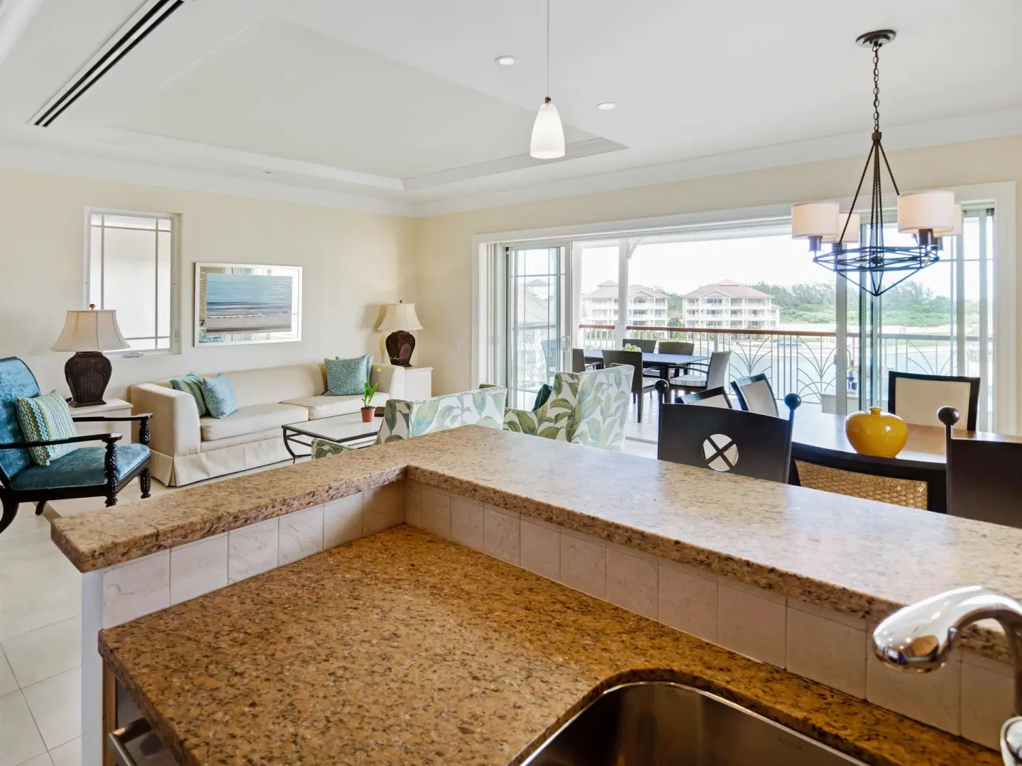 Open villa suite living and dining area with marina-facing balcony at The Landings Resort & Spa.
