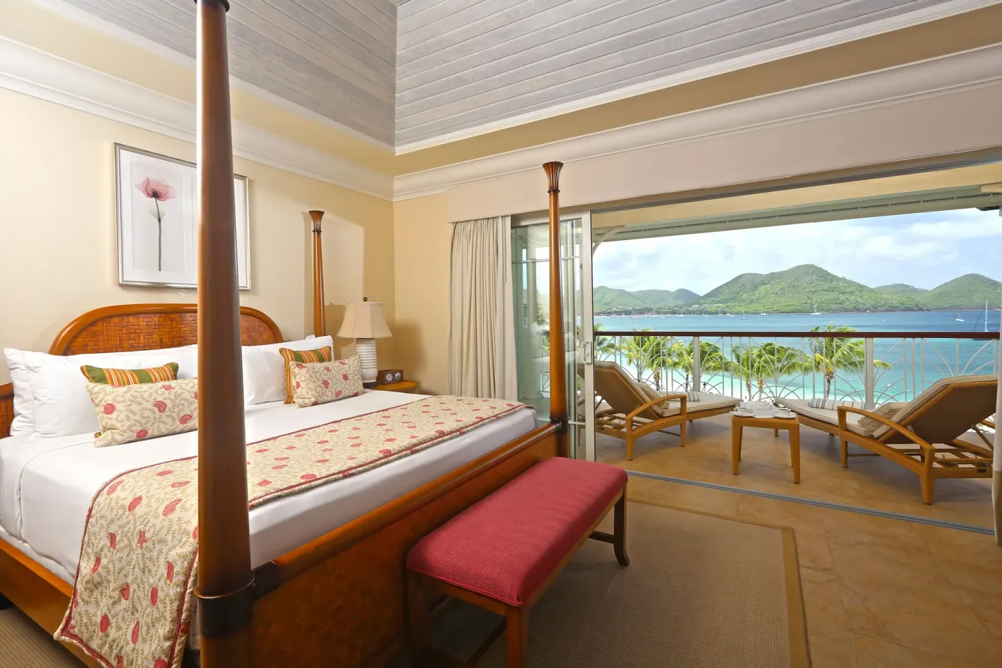 Four-poster bedroom with balcony and sea view at The Landings Resort & Spa.