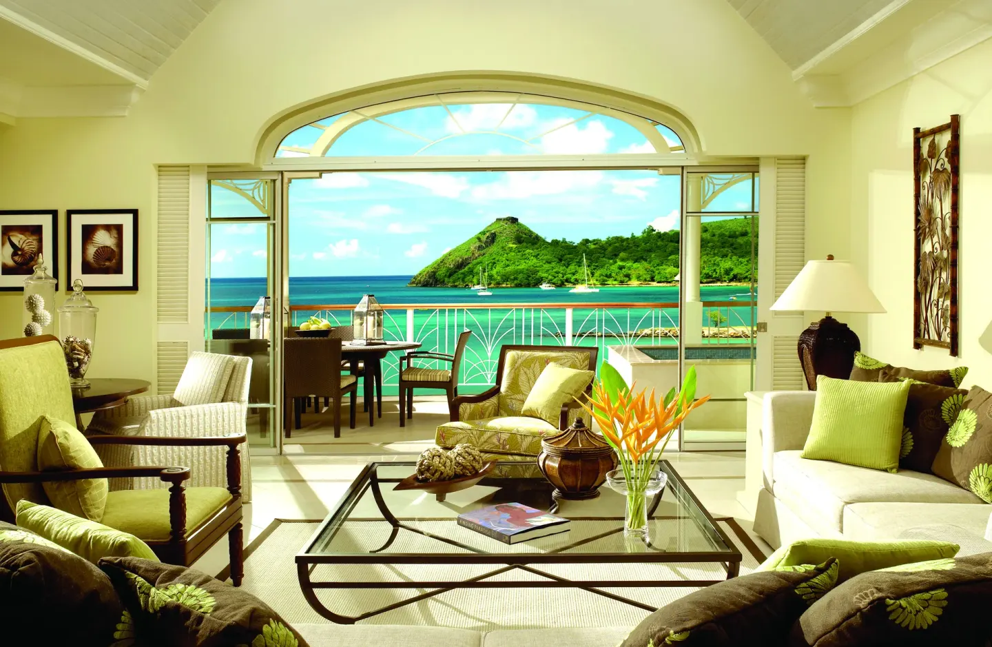 Villa living room with arched balcony doors and ocean view at The Landings Resort & Spa.