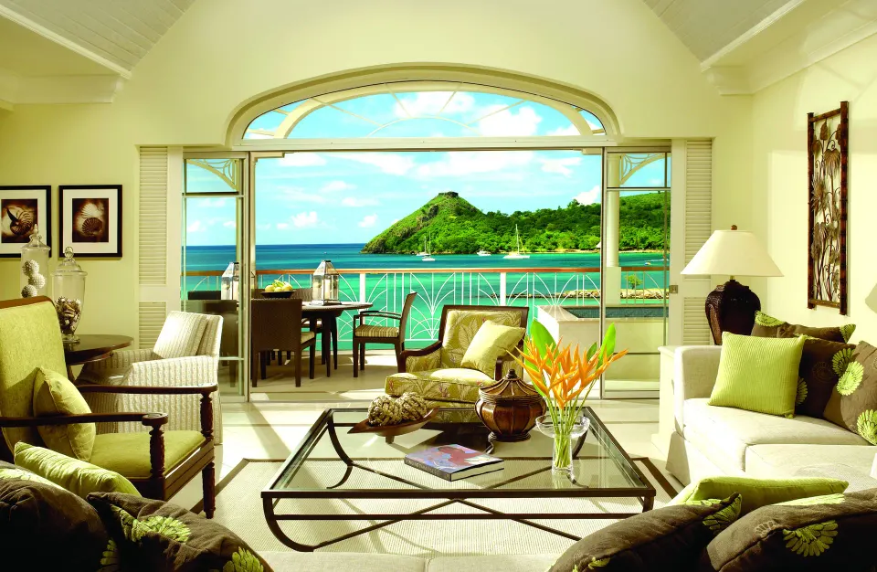 Villa living room with arched balcony doors and ocean view at The Landings Resort & Spa.