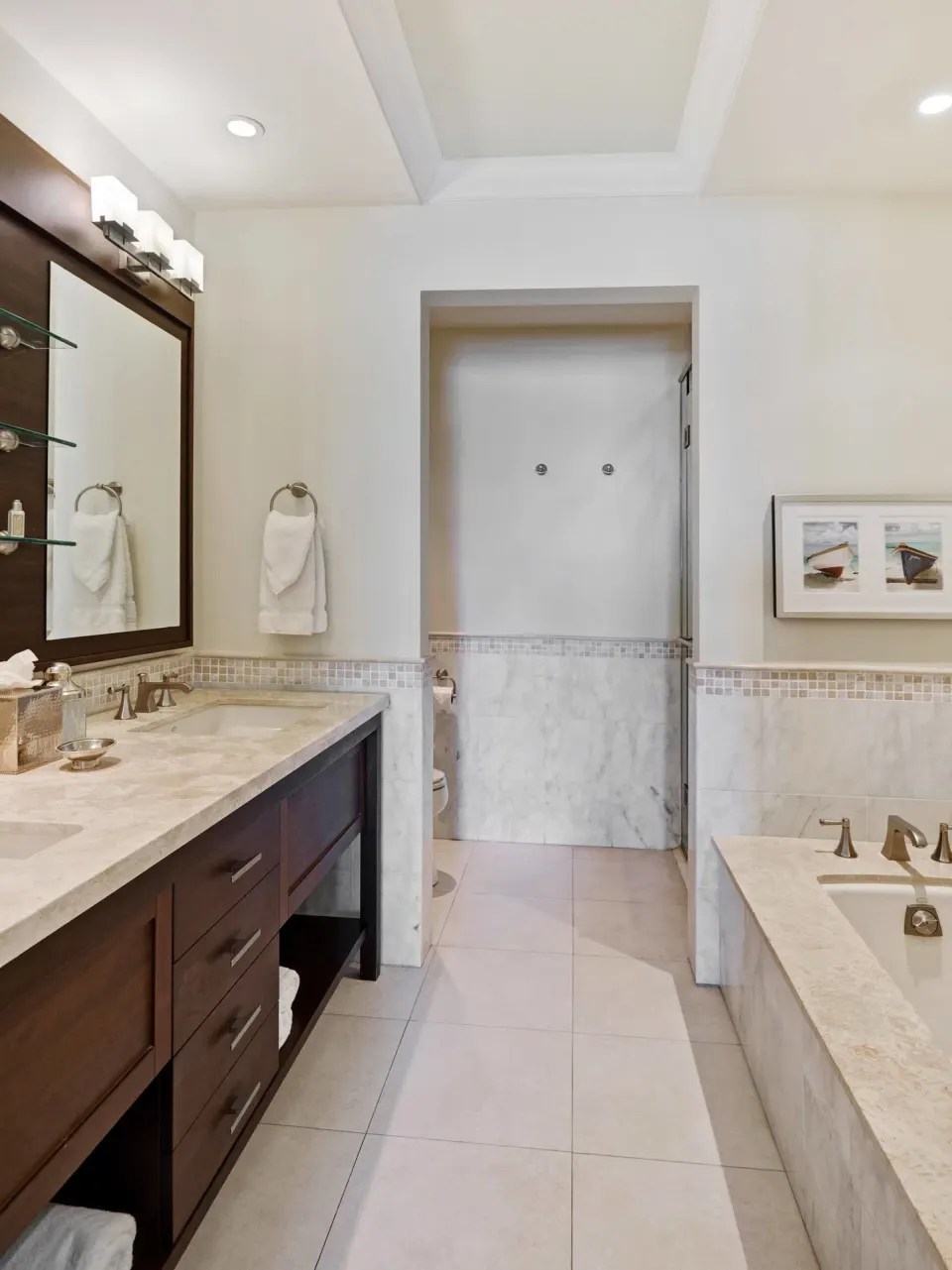 Marble bathroom in a 2 Bedroom Marina View Villa Suite at The Landings Resort & Spa with tub and vanity.