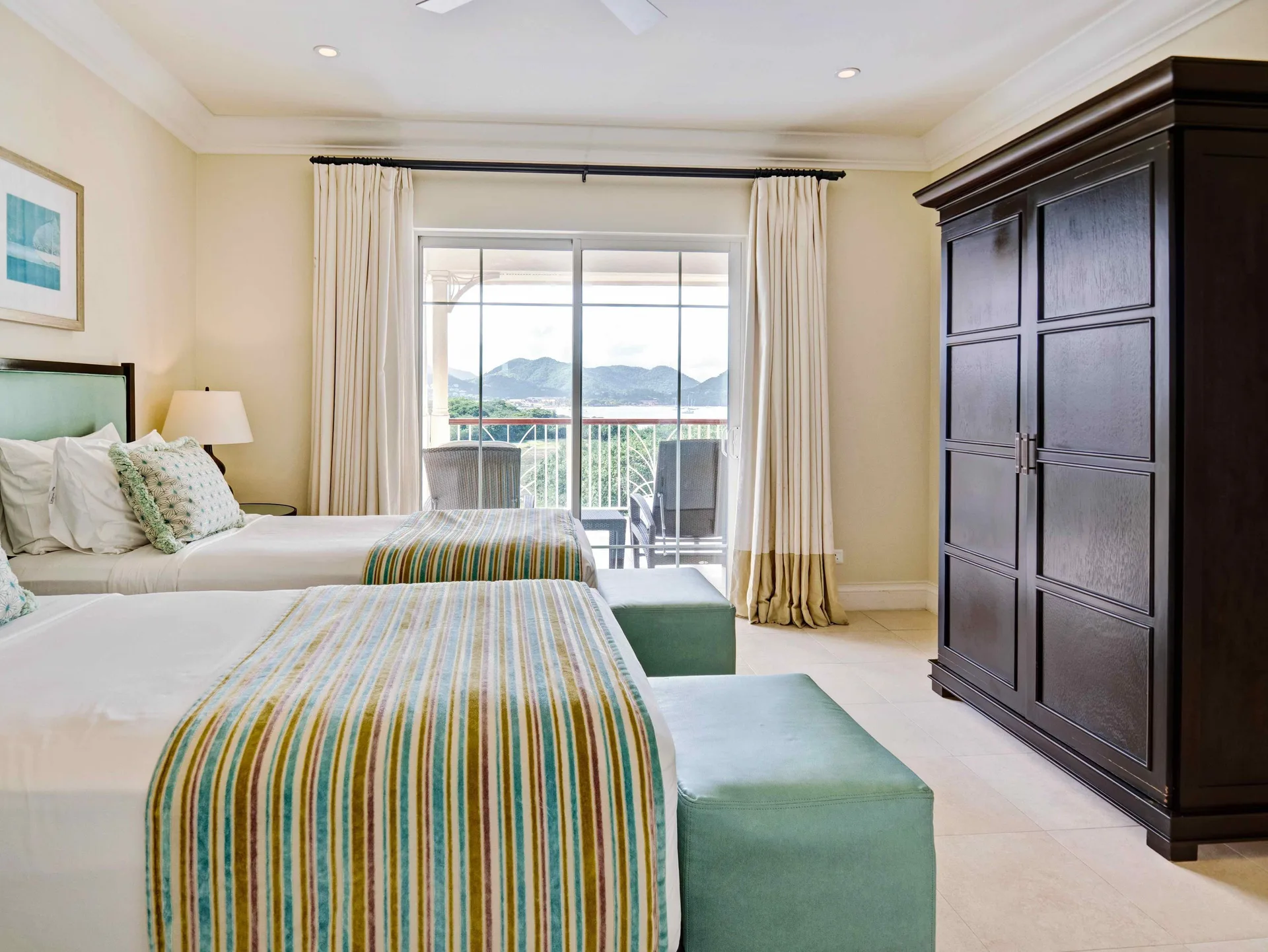 Twin bedroom in a marina view villa suite at The Landings Resort & Spa with balcony and mountain view.