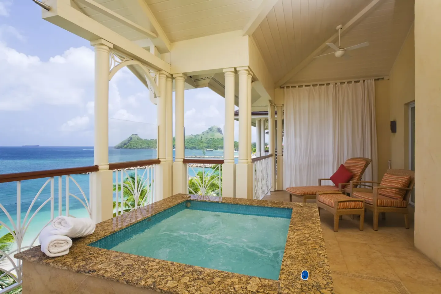 Covered balcony plunge pool at The Landings Resort & Spa with lounge chairs and sea view.
